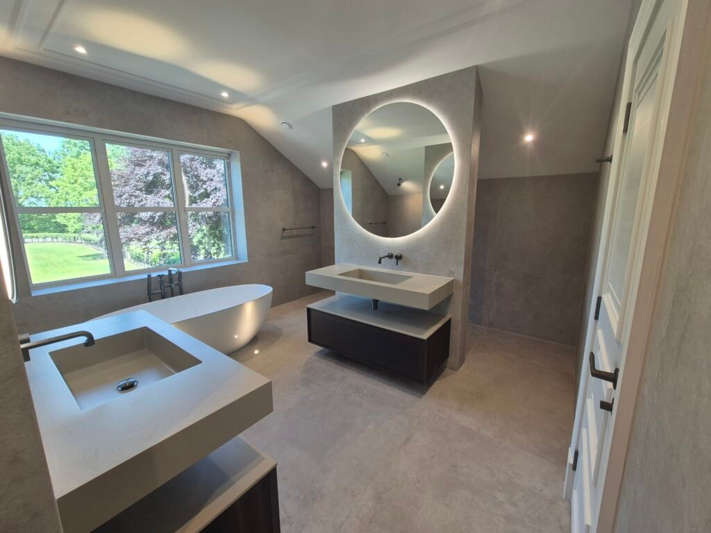 Freshly resealed domestic bathroom with freestanding bath and twin basins