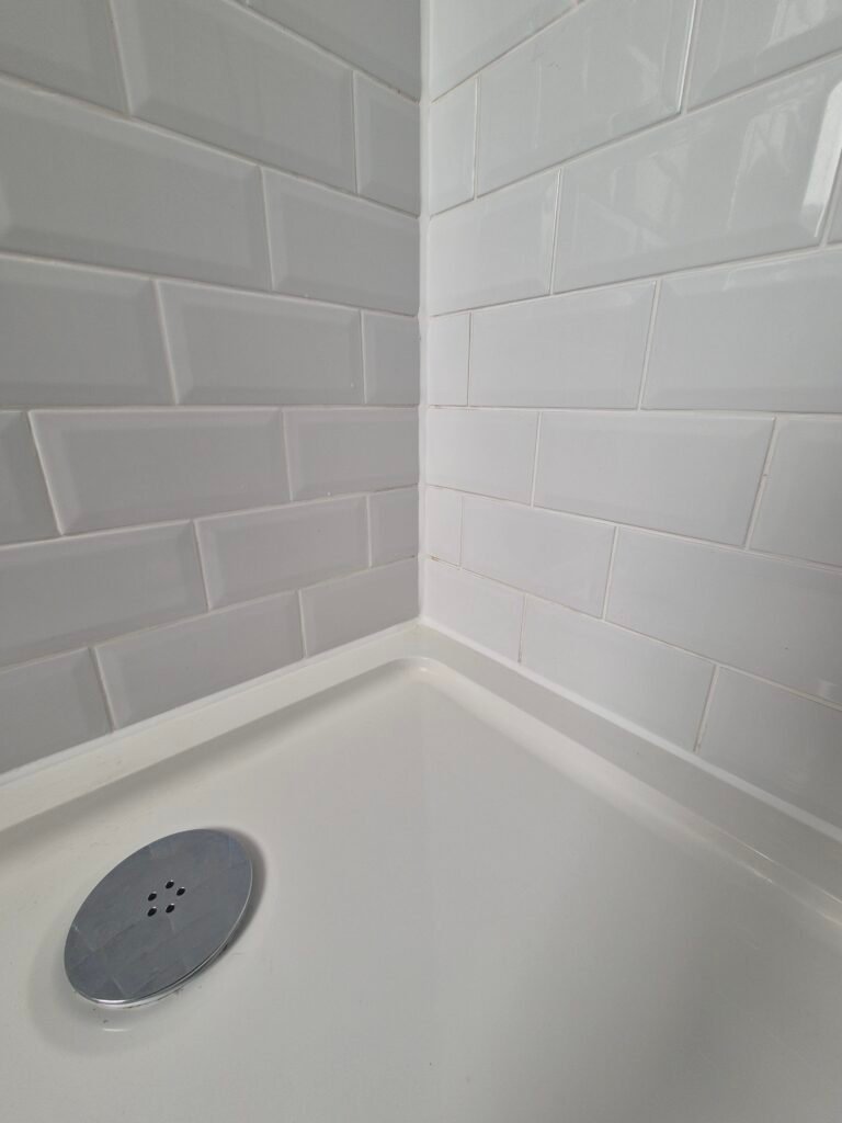 Repaired and resealed shower enclosure after a leak was traced to failed silicone